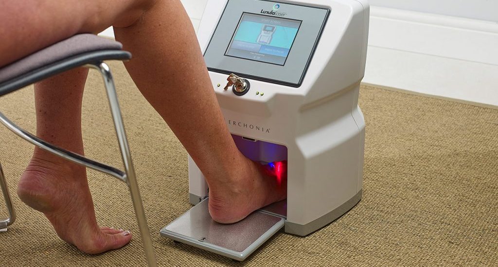 Fungal nail laser treatment being delivered in a podiatry clinic